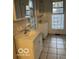 Bathroom features white vanity, dual sinks, and tiled floors at 2842 Indianapolis Ave, Indianapolis, IN 46208