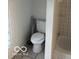The bathroom includes a white toilet, tiled flooring, and built-in storage at 2842 Indianapolis Ave, Indianapolis, IN 46208