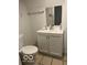 This bathroom features a vanity with a sink, a toilet, and tiled flooring at 2842 Indianapolis Ave, Indianapolis, IN 46208