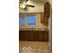 Functional kitchen area with ample counter space, window views, and tile flooring at 2842 Indianapolis Ave, Indianapolis, IN 46208