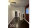 Cozy living room with wood floors, neutral walls, and a view of connecting rooms at 2842 Indianapolis Ave, Indianapolis, IN 46208
