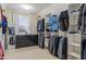 A walk-in closet is well-organized with shelving, hanging racks, and a dresser at 3322 Paisley Pointe, Whitestown, IN 46075