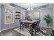 A dining room features a marble table, seating for four, and decor at 3322 Paisley Pointe, Whitestown, IN 46075