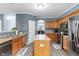 Well-equipped kitchen with wood cabinetry, stainless steel appliances, and ample countertop space at 3322 Paisley Pointe, Whitestown, IN 46075