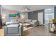 Comfortable living room with stylish decor, including a modern sofa, unique artwork, and a ceiling fan at 3322 Paisley Pointe, Whitestown, IN 46075