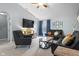 A living room featuring two sofas, two chairs, and a flat-screen TV with natural lighting at 3322 Paisley Pointe, Whitestown, IN 46075
