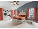 A bedroom features a sloped ceiling, a bed with an orange comforter, and a hanging chair at 3322 Paisley Pointe, Whitestown, IN 46075