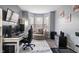 A home office is well-lit, with a desk, shelving, and circular couch for relaxing at 3322 Paisley Pointe, Whitestown, IN 46075