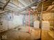 Unfinished basement features a laundry area and concrete block wall at 3455 Hillside Ave, Indianapolis, IN 46218