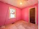 Small bedroom with pink walls featuring one window at 3455 Hillside Ave, Indianapolis, IN 46218