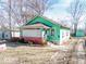 Inviting single Gathering home with green exterior, classic porch, and nice curb appeal, ready for its next chapter at 3455 Hillside Ave, Indianapolis, IN 46218