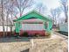 Charming home features a cozy covered porch with brick accents and a well-maintained front yard, ready for personalization at 3455 Hillside Ave, Indianapolis, IN 46218
