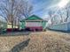 Classic home with a cozy porch, nestled among mature trees with great potential for a lovely yard at 3455 Hillside Ave, Indianapolis, IN 46218
