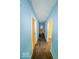 View of the hallway with blue walls and wood floor, with multiple doors at 3455 Hillside Ave, Indianapolis, IN 46218