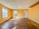 Inviting living room showcasing hardwood floors, sunny windows and an open doorway at 3455 Hillside Ave, Indianapolis, IN 46218