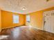 Bright living room with hardwood floors and large windows, offering ample natural light at 3455 Hillside Ave, Indianapolis, IN 46218