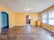 Cozy living room featuring hardwood floors, natural light, and convenient access to the kitchen at 3455 Hillside Ave, Indianapolis, IN 46218