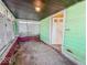 Enclosed front porch of home, offering a transitional space with a blend of functionality and classic design at 3455 Hillside Ave, Indianapolis, IN 46218