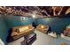 The partially finished basement has couches, string lights, and a pet resting in its bed at 36 Bankers Ln, Indianapolis, IN 46201