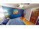 Bedroom with a large bed, hardwood floors, and colorful art on the wall at 36 Bankers Ln, Indianapolis, IN 46201