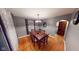 Open dining area featuring a wood table, neutral walls and curtains, and hardwood flooring at 36 Bankers Ln, Indianapolis, IN 46201