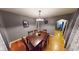 Inviting dining room with wood floors, neutral walls, and a stylish chandelier over a wood table at 36 Bankers Ln, Indianapolis, IN 46201