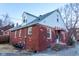 The exterior elevation of this red brick house shows a clean yard at 36 Bankers Ln, Indianapolis, IN 46201
