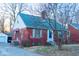 Quaint brick home boasting an attached garage, complemented by a well-maintained yard and driveway at 36 Bankers Ln, Indianapolis, IN 46201