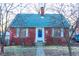Charming brick home featuring a blue door, complemented by white trim and inviting curb appeal at 36 Bankers Ln, Indianapolis, IN 46201
