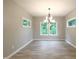Bright dining area with hardwood floors and large windows offering a scenic view at 3604 Maple Ridge Dr, Columbus, IN 47201