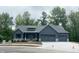 Charming one-story home boasts a gray exterior, three-car garage, and stone accents at 3604 Maple Ridge Dr, Columbus, IN 47201