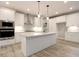 Bright kitchen with white cabinets, stainless steel appliances, granite countertops, and a large island at 3604 Maple Ridge Dr, Columbus, IN 47201