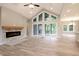 Open living room featuring a stone fireplace, large windows, hardwood floors and a high ceiling at 3604 Maple Ridge Dr, Columbus, IN 47201