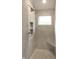 Tiled shower with built-in seat, recessed shelf, and modern fixtures at 3604 Maple Ridge Dr, Columbus, IN 47201