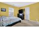Bedroom featuring yellow walls, a queen-sized bed, and a large window at 3844 Kilburn Ct, Indianapolis, IN 46228