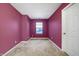 Carpeted bedroom featuring a neutral carpet, a window, and a smooth painted wall at 3844 Kilburn Ct, Indianapolis, IN 46228