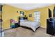 Bright bedroom with a queen-sized bed, a large window, and a television at 3844 Kilburn Ct, Indianapolis, IN 46228