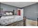 Serene bedroom boasting a wooden bed frame, plush bedding, and a calming gray color palette at 3844 Kilburn Ct, Indianapolis, IN 46228