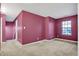 Spacious carpeted bedroom featuring a neutral carpet, a window, and a smooth painted wall at 3844 Kilburn Ct, Indianapolis, IN 46228