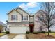 Charming two-story home with a two-car garage, brick and siding exterior, and well-maintained landscaping at 3844 Kilburn Ct, Indianapolis, IN 46228