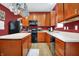 Bright kitchen with plenty of counter space, black appliances, and hanging pot rack at 3844 Kilburn Ct, Indianapolis, IN 46228