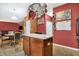Open concept kitchen with center island, hanging pot rack and adjacent dining area at 3844 Kilburn Ct, Indianapolis, IN 46228