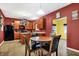 Well-lit dining area with a modern kitchen, dark appliances, and tile flooring at 3844 Kilburn Ct, Indianapolis, IN 46228