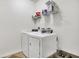 Well-organized laundry area with white washer and dryer, storage shelves, and ample space at 3844 Kilburn Ct, Indianapolis, IN 46228