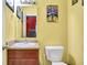 Cute powder room with vanity, sink, toilet and fun superman art at 3844 Kilburn Ct, Indianapolis, IN 46228
