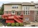 Rear exterior features deck, sliding door, brick facade, and green landscaping at 3880 Heathfield Ct, Zionsville, IN 46077