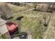 Overhead shot showing backyard with deck, landscaped mulch beds, black metal fence, and grassy lawn at 3880 Heathfield Ct, Zionsville, IN 46077