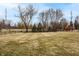 Fenced backyard with mature trees and a playset, providing a great outdoor space at 3880 Heathfield Ct, Zionsville, IN 46077
