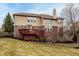 Back exterior featuring a spacious yard and a two-story home with a prominent wooden deck at 3880 Heathfield Ct, Zionsville, IN 46077