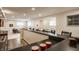 Basement bar area with seating overlooks additional living space; perfect for entertaining guests at 3880 Heathfield Ct, Zionsville, IN 46077
